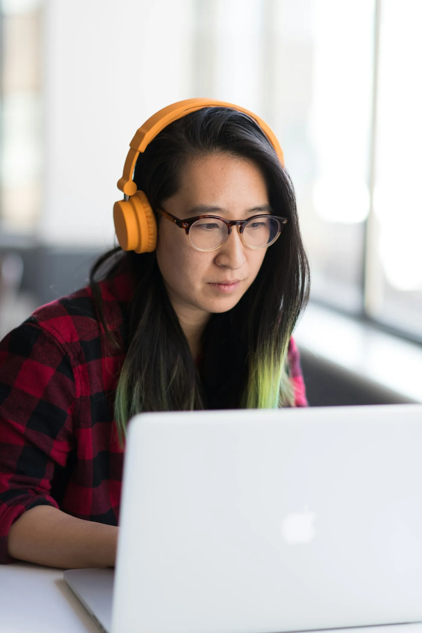 Businesswoman using a laptop with headphones